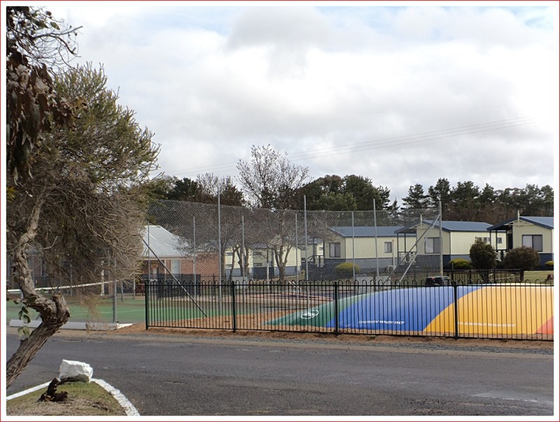 Jumping pillow, tennis court, swimming pool and cabins at Capital Country Holiday Park